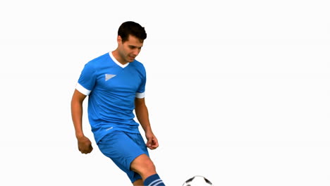 Attractive man juggling a football on white screen