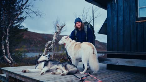 man with his pet dogs getting ready for hiking in åfjord, norway - static shot