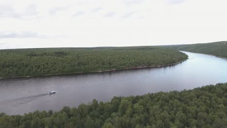 flying over a large river in the untouched nature in russia