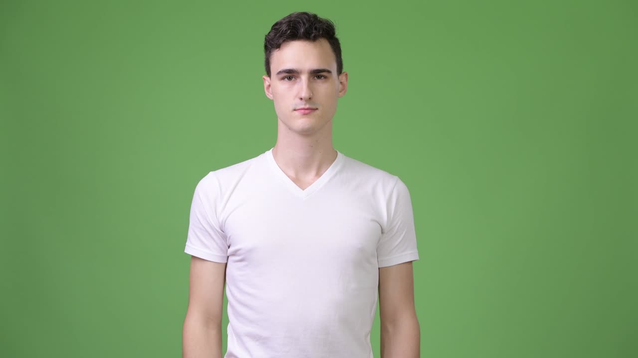 Young handsome man pointing at camera