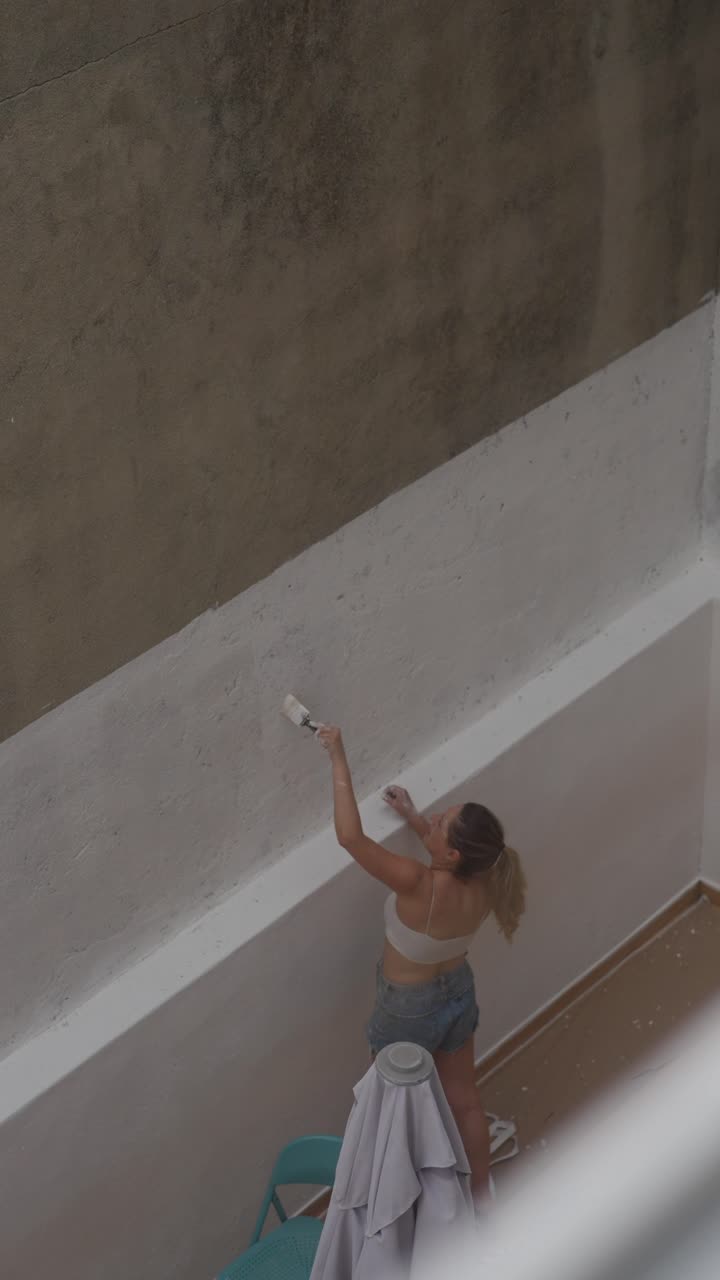 Donna che dipinge un muro