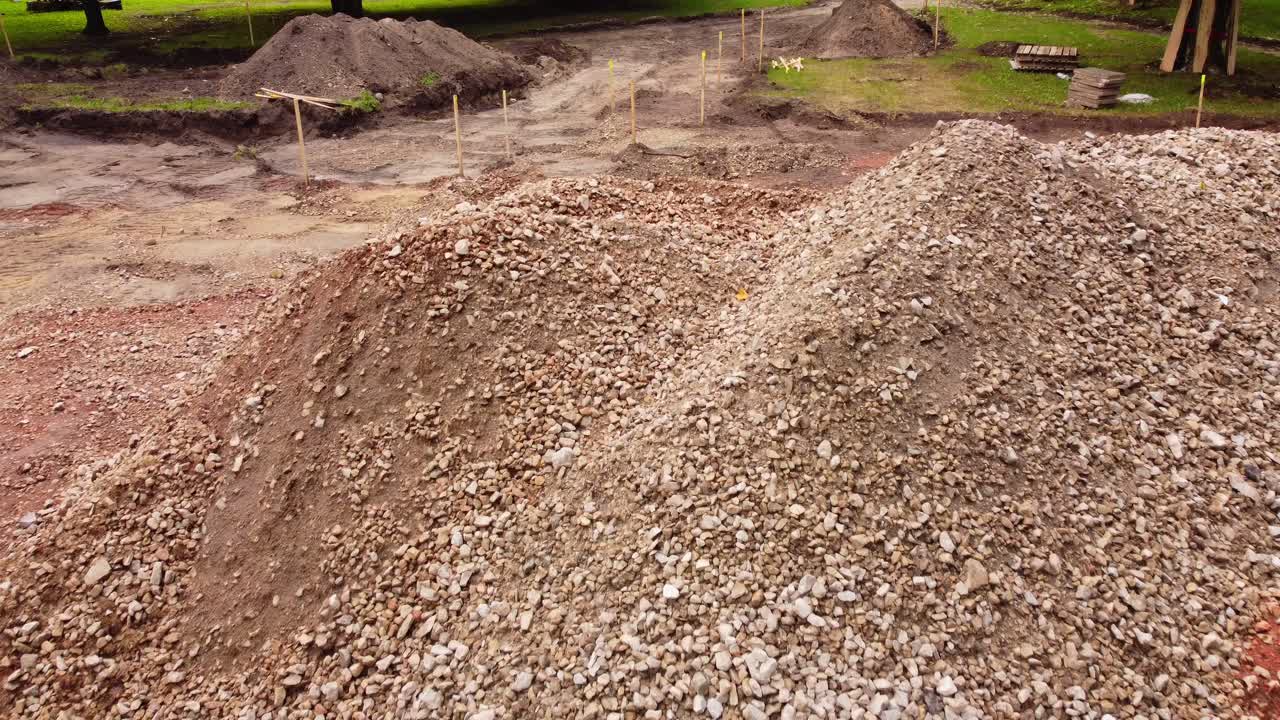 Drone shot of groundwork with gravel in park for playground.