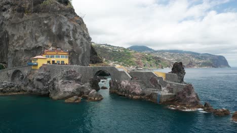 Scenic-panoramic-viewpoint-on-cliffs-at-shore-of-Ponta-do-Sol,-aerial