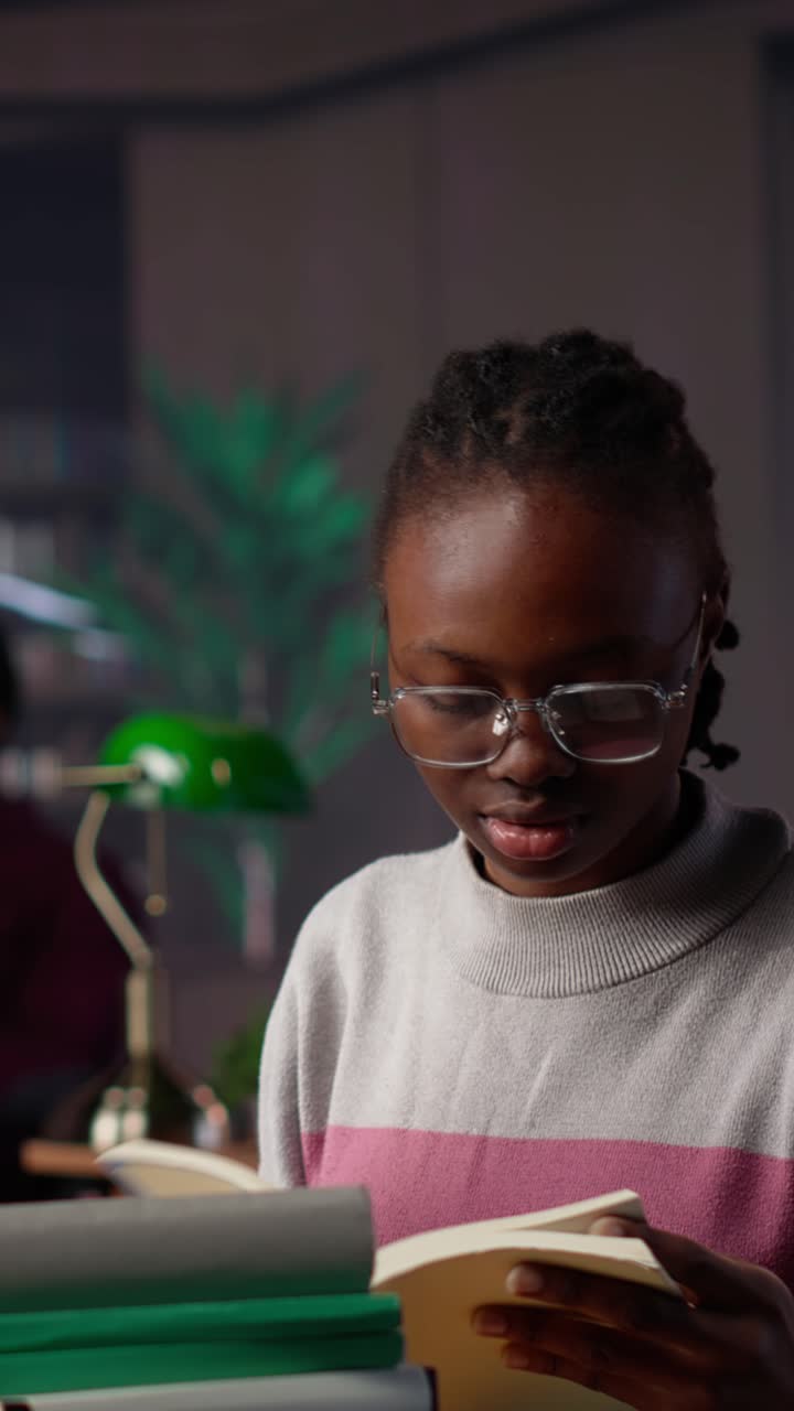 Vertical video african american girl does bachelor paper research for citations and information