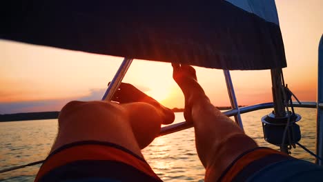 close up shot relaxed traveler man legs on motorboat on beautiful island and mountain carefree concept