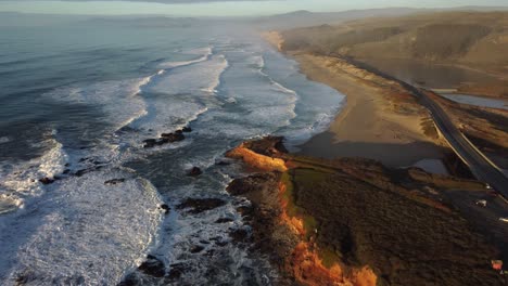 drone shot moving along pescadero state beach