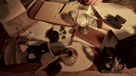 vintage study table with books, papers, camera and other items
