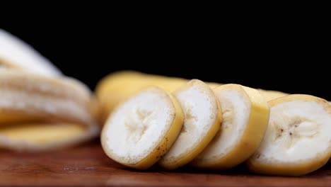 Plátano-Fresco-Y-Jugoso-Sobre-Una-Tabla-De-Cortar-De-Madera-Marrón,-Primer-Plano