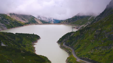 Cinematic-reverse-aerial-shot-of-a-reservoir-in-Switzerland