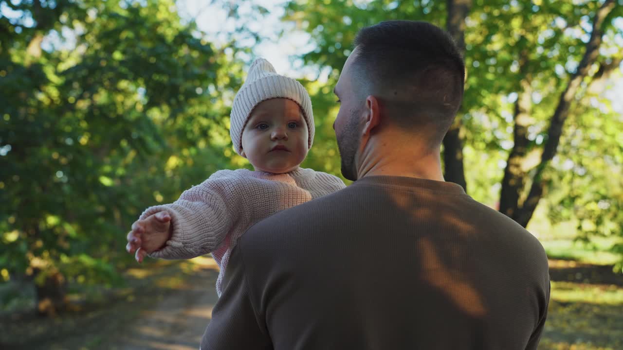 Father carrying his daughter in the park