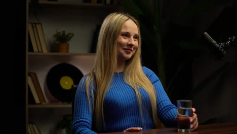 woman in interview with glass of water