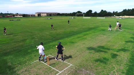 drone shot of kids playing school cricket durban south africa