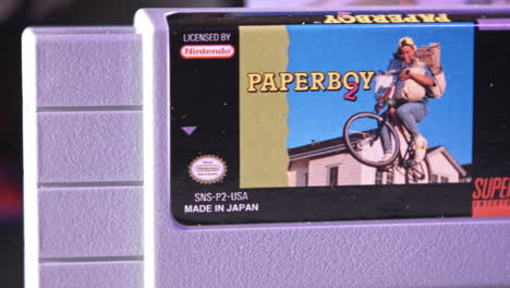vintage super nintendo cartridge and box in purple light slide left