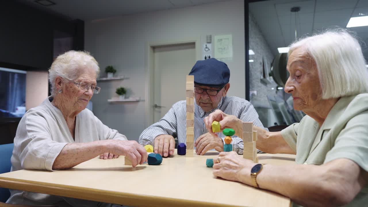 Elderly people playing a game with wooden blocks