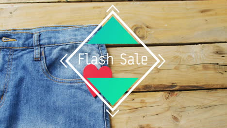 animación de texto de venta flash sobre pantalones de denim sobre fondo de madera