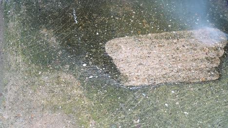 jetwashing a dirty concrete path