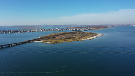 an aerial shot of elevated train tracks over a bay in queens, ny