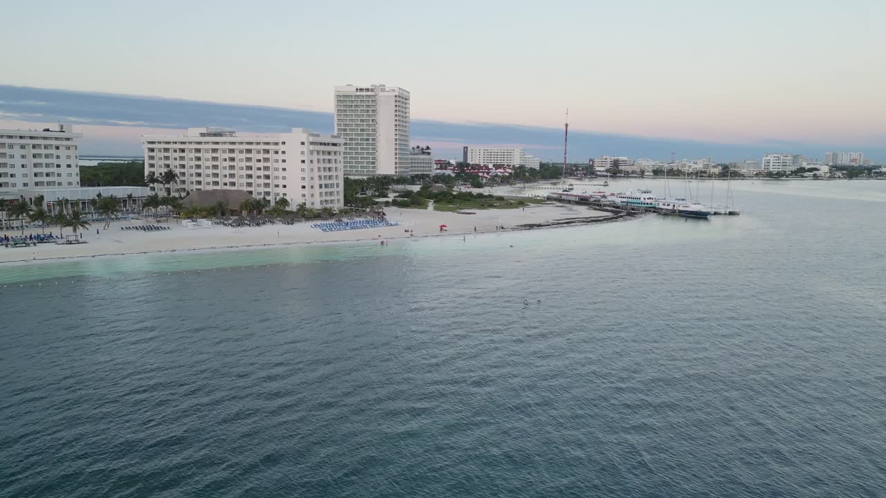 Cancun's playa langosta beach, showcasing resorts and calm waters, aerial view