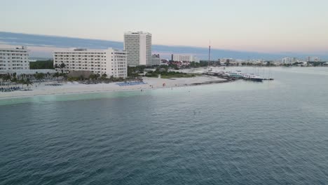 cancun's playa langosta beach, showcasing resorts and calm waters, aerial view