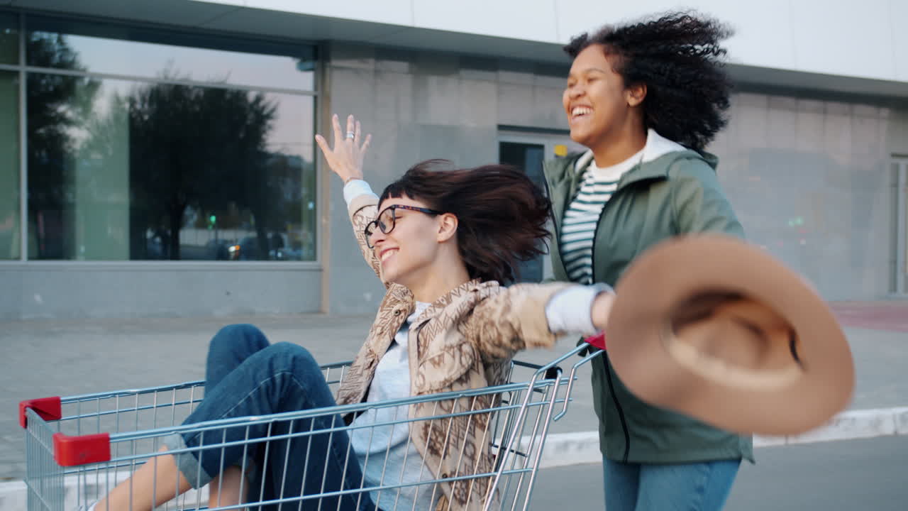 Two friends having fun with a shopping cart