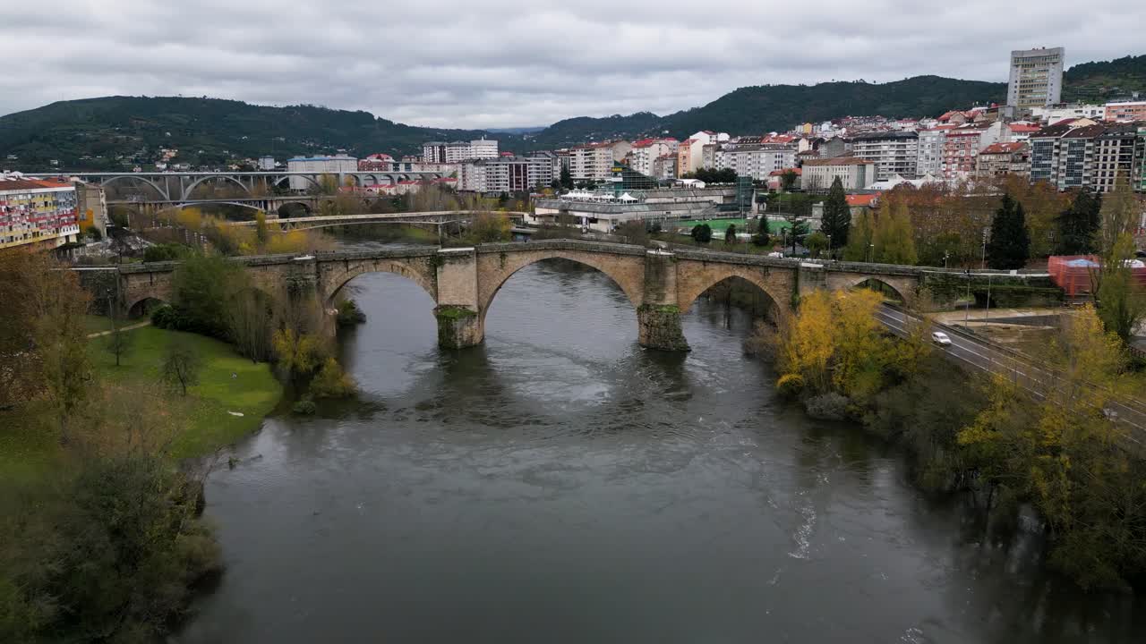 Aerial push in to Ourense Roman Bridge on Mi&ntilde;o River in Ourense, Galicia, Spain