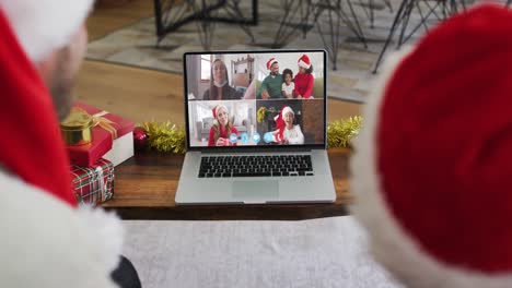 Caucasian-couple-having-a-christmas-video-call-with-family