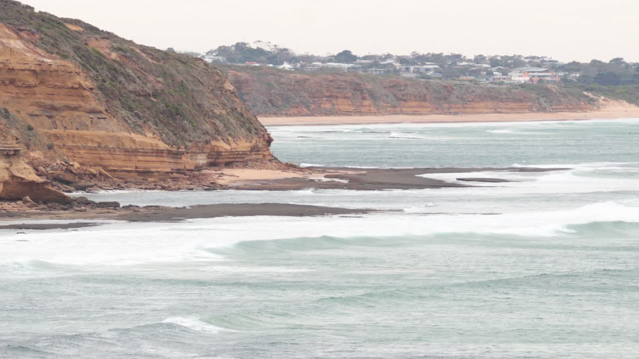 Waves hitting rocky shore at Torquay Beach