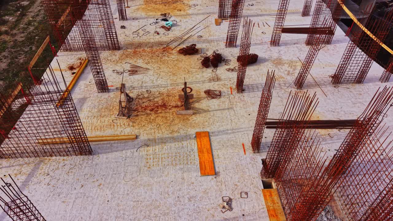 Construction site activity captured from above, showing extensive work