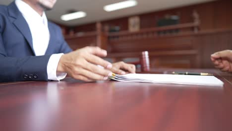 businessman and male lawyer shaking hands to seal a deal with his partner lawyers,law and legal services concept.