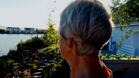 senior woman standing in backyard 4k