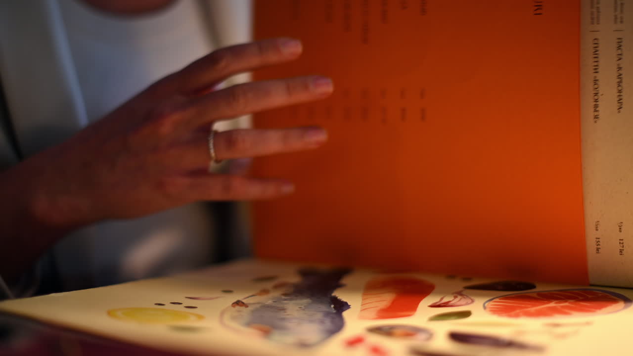 Woman reading a fish menu at a restaurant at lunch