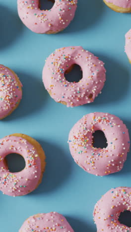 video of donuts with icing on blue background