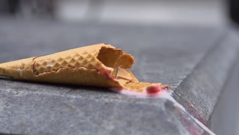 slow motion shot of an ice cream falling on the ground