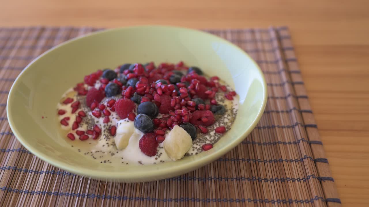 Close-up panning shot of healthy homemade yoghurt on table served for breakfast
