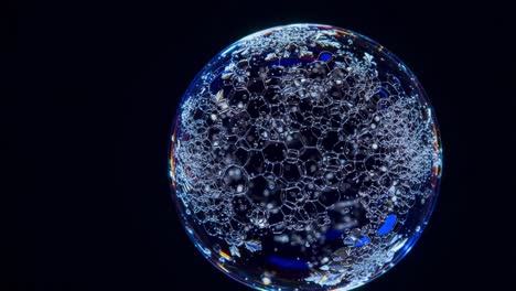 a stunning visualization of a soap bubble capturing complex patterns and reflections in a dark background, demonstrating nature's intricate beauty and structure