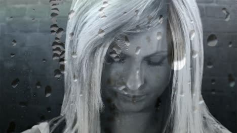 water drops over a glass effect over stressed caucasian woman against grey background