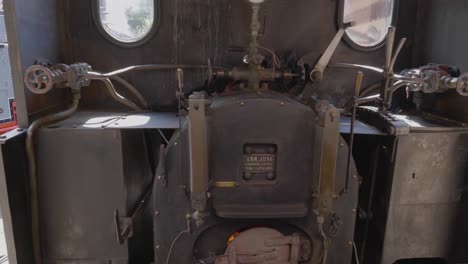 inside small narrow-gauge steam locomotive, firebox glowing redblonay-chamby museum track, switzerland