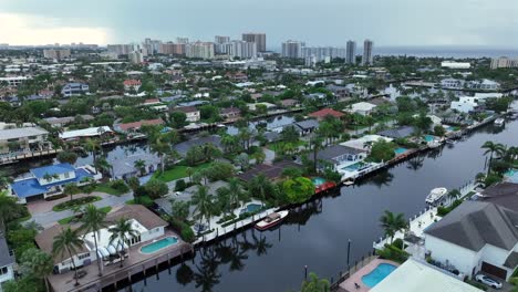 aerial view of coastal waterfront homes with canals and city skyline