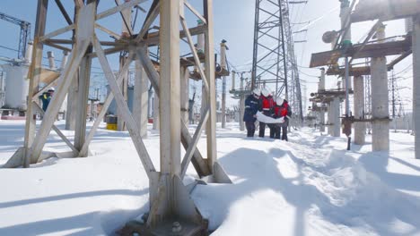 power plant engineers reviewing plans in snowy conditions