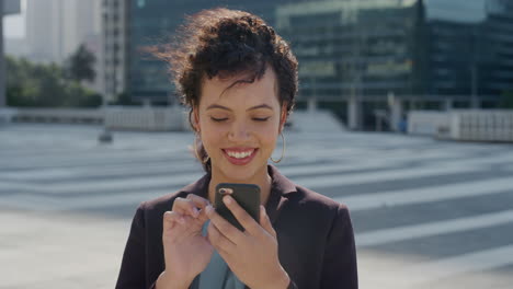portrait beautiful young hispanic business woman using smartphone texting browsing messages enjoying mobile phone communication in city slow motion