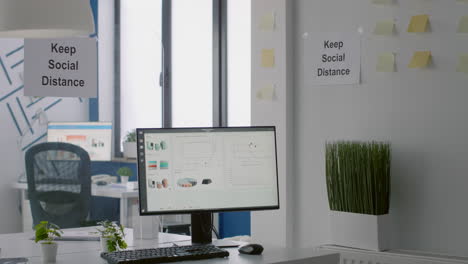 empty business modern office with plastic separators and keep social distance sign on the wall