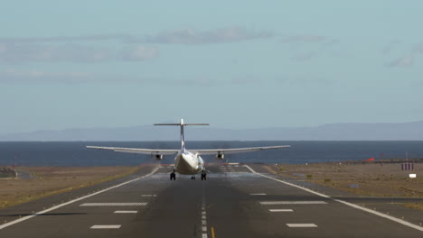 jetliner landing on runway by the sea