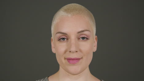 female model poses for camera in front of grey backdrop 04