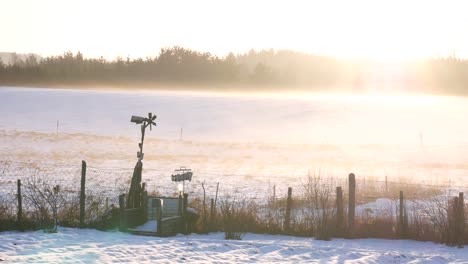 winter sunny day with an old style handmade windmill and sun leaks