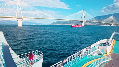 ferry crossing under the rio-antirio bridge in greece