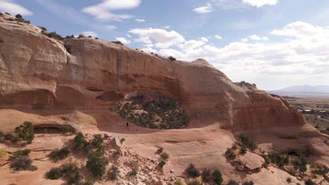 aerial pedestal up at wilson arch geological rock formation in utah, usa