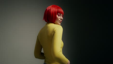 woman with red wig and yellow sweater