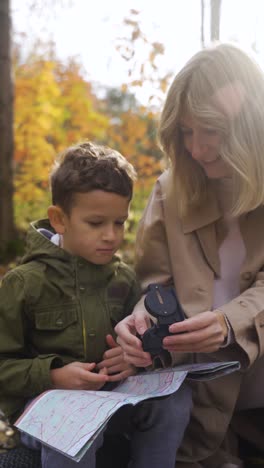 Mother-and-son-sitting-at-the-forest