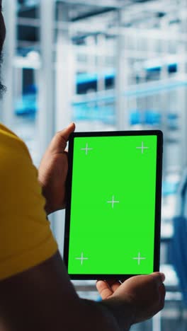 vertical video smart factory expert using green screen tablet to test automated systems