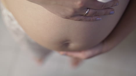 pregnant woman with hands on the belly